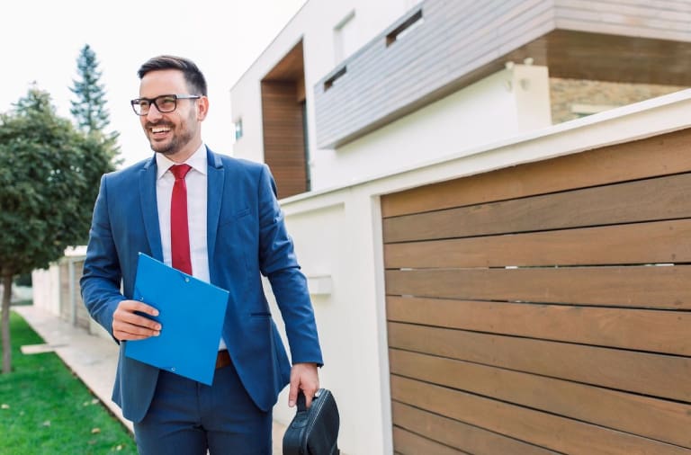 A man in a suit and tie holding papers