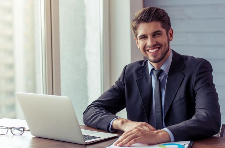 A man sitting at his desk with a laptop.